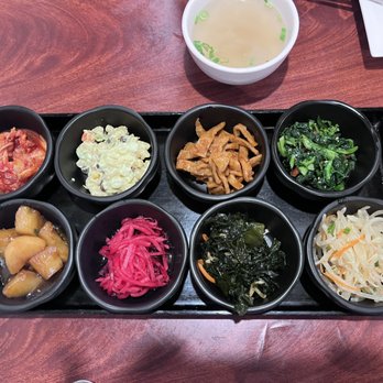 Daol Tofu - The banchan array!  Clear chicken soup above, also part of meal. - Korean Near Me - Oakland, California