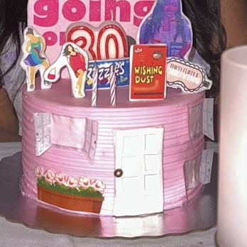 Elite Cake Creations - a woman sitting in front of a birthday cake - Bakeries Near Me - Cooper City, Florida