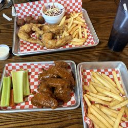 The Poop Deck Bar and Grill - Six piece wings with fries and basket of frog legs with hush puppies