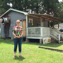 a woman standing in front of a house