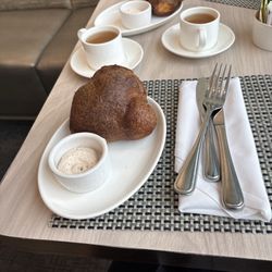 NM Cafe - Freshly made popover with strawberry butter and a cup of hot bone broth served on the house.