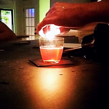Nate's - Lighting up the orange peel for the aromatics - Cocktail Bars Near Me - Buda, Texas Nate's - Lighting up the orange peel for the aromatics - Cocktail Bars Near Me - Buda, Texas