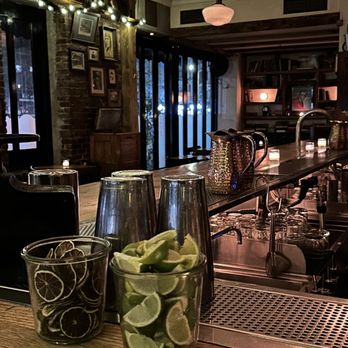 Goodnight Sonny - a view of a bar with two glasses of water and lime slices - Cocktail Bars Near Me - New York, New York Goodnight Sonny - a view of a bar with two glasses of water and lime slices - Cocktail Bars Near Me - New York, New York