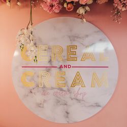 Cereal and Cream - A sign under a ceiling of flowers that reads "cream and cereal"