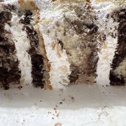 Marble cake with what should have been almond praline bavarian cream filling. It's clearly whipped cream with almond slivers. Marble cake with what should have been almond praline bavarian cream filling. It's clearly whipped cream with almond slivers.