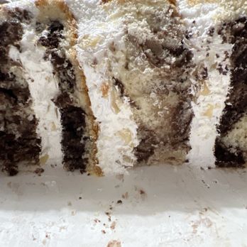 Butter + Cream Bakery - Marble cake with what should have been almond praline bavarian cream filling. It's clearly whipped cream with almond slivers. - Bakeries Near Me - Laguna Niguel, California Butter + Cream Bakery - Marble cake with what should have been almond praline bavarian cream filling. It's clearly whipped cream with almond slivers. - Bakeries Near Me - Laguna Niguel, California