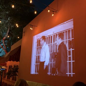 Scarlett - A movie projected on the wall of the restaurant - Italian Near Me - West Hollywood, California Scarlett - A movie projected on the wall of the restaurant - Italian Near Me - West Hollywood, California