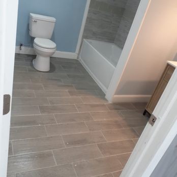 Vish And Brother - a bathroom with a toilet and bathtub - General Contractors Near Me - Schenectady, New York Vish And Brother - a bathroom with a toilet and bathtub - General Contractors Near Me - Schenectady, New York