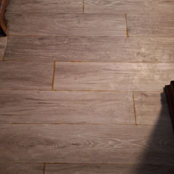 Empire Today - Broad area photo of grime between joints of flooring planks that may not have been properly installed - Carpet Installation Near Me