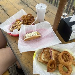 Reuben sandwich with onion rings and also a chili cheese dog and slaw dog Reuben sandwich with onion rings and also a chili cheese dog and slaw dog