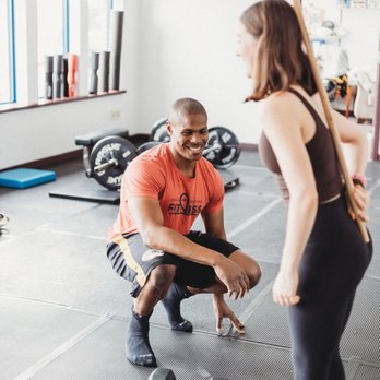 Simple Solutions Fitness - Steven coaching Emma on how to hinge using a dowel - Trainers Near Me - Columbia, Missouri Simple Solutions Fitness - Steven coaching Emma on how to hinge using a dowel - Trainers Near Me - Columbia, Missouri