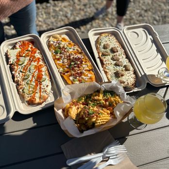 Pour Folk Provisions - four trays of food on a picnic table - Pizza Near Me - Lexington, North Carolina Pour Folk Provisions - four trays of food on a picnic table - Pizza Near Me - Lexington, North Carolina