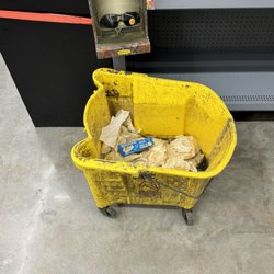 Walmart Supercenter - Dirty mop bin. literally soo gross bugs flying in and out of it. just sitting in the middle of the store