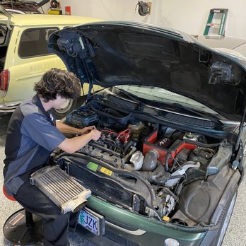 Tuner Automotive - Technician performing valve cover gasket repair on 2006 Mini Cooper S. - Auto Repair Near Me - Bend, Oregon Tuner Automotive - Technician performing valve cover gasket repair on 2006 Mini Cooper S. - Auto Repair Near Me - Bend, Oregon