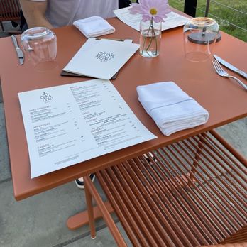Cenadou Bistrot - a man sitting at a restaurant table - French Near Me - North Salem, New York Cenadou Bistrot - a man sitting at a restaurant table - French Near Me - North Salem, New York