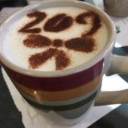 a cup of cappuccino on a table a cup of cappuccino on a table