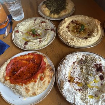 Othello - From bottom left to right: harissa bread, whipped feta, babaganoush, hummus, za'atar bread. All delish! - Seafood Near Me - Jacksonville, Florida