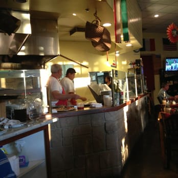 Spuntino Pizzeria - Filipino making pizza in the wood fire oven. He makes awesome thin crust pizza! - Italian Near Me - Temecula, California Spuntino Pizzeria - Filipino making pizza in the wood fire oven. He makes awesome thin crust pizza! - Italian Near Me - Temecula, California