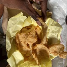 a hand grabbing a piece of bread a hand grabbing a piece of bread