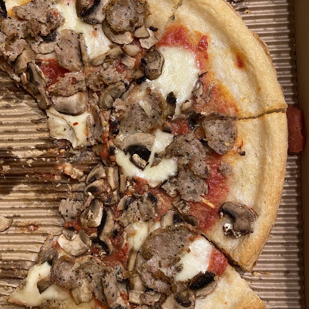 a half eaten pizza in a box a half eaten pizza in a box