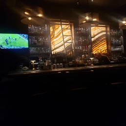 Cool back-lit walls behind the bar Cool back-lit walls behind the bar