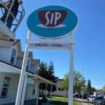 Sip Coffee Bar - a sign for sip drive thru - Coffee & Tea Near Me
