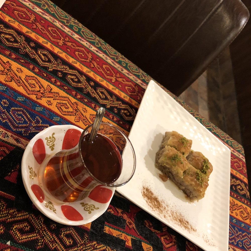 a plate of food and a glass of tea