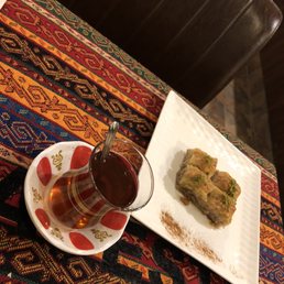 a plate of food and a glass of tea