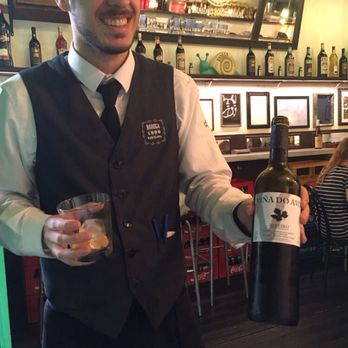 Bodega 1900 - My very handsome server holding the bottle of Ribeiro that he recommended for the courses he picked for me. - Tapas/Small Plates Near Me - Barcelona, B