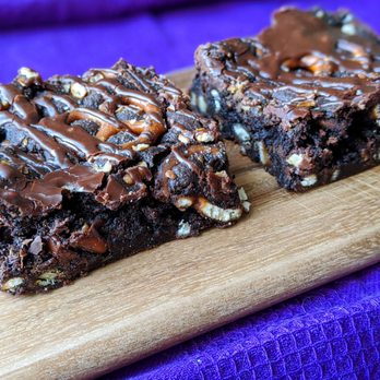 Fetching Goodies - three pieces of chocolate brownie on a cutting board - Vegan Near Me Fetching Goodies - three pieces of chocolate brownie on a cutting board - Vegan Near Me