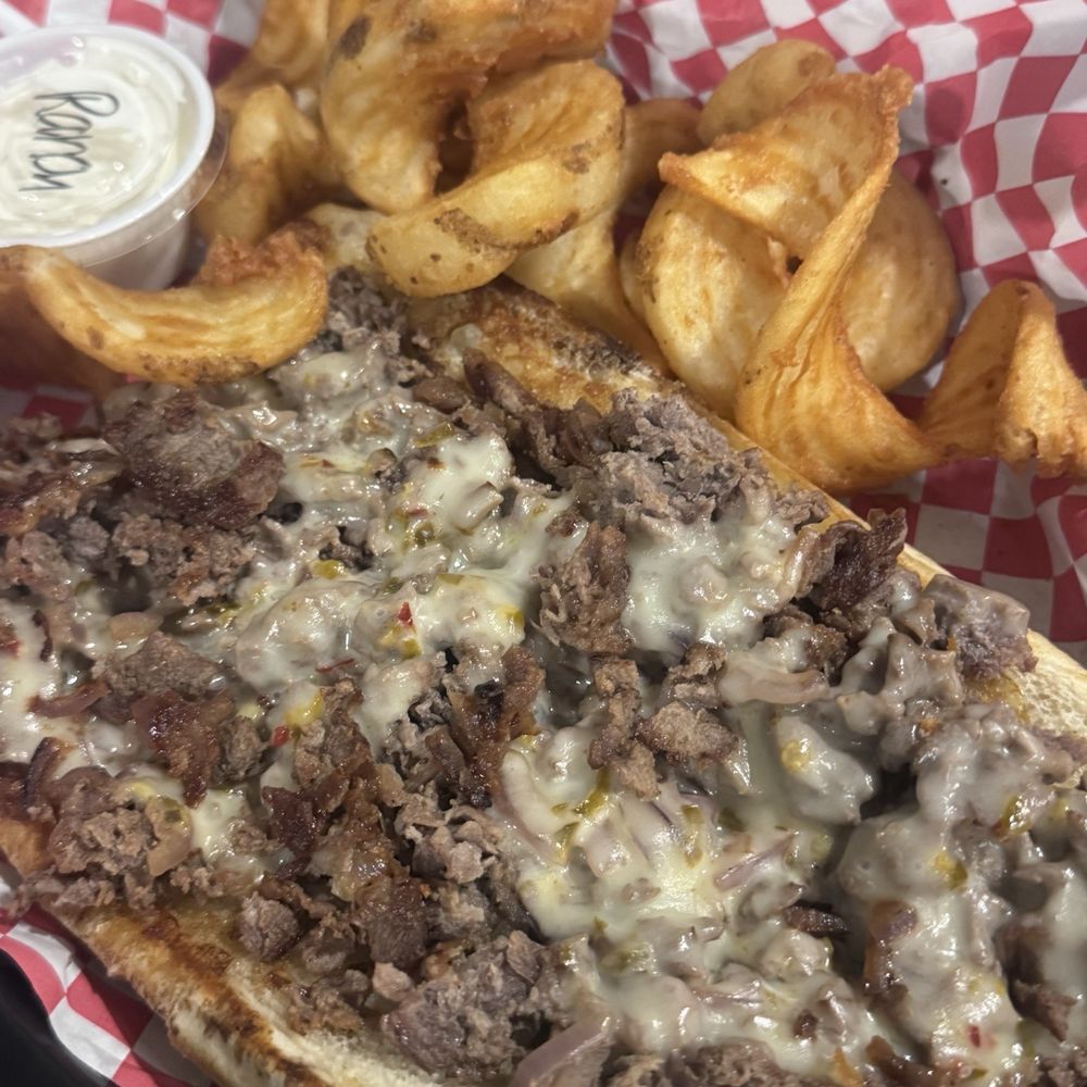 Off The Hook Tavern - Philly Cheesesteak (no peppers or mushrooms) and a side of their Sidewinder Fries. - American Near Me - Pulaski, New York Off The Hook Tavern - Philly Cheesesteak (no peppers or mushrooms) and a side of their Sidewinder Fries. - American Near Me - Pulaski, New York
