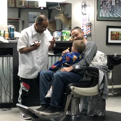 Englewood Barber Shop - Eddie patiently working to cut a 2 year old's hair :)