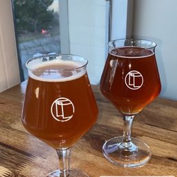 two glasses of beer on a table two glasses of beer on a table