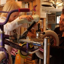 Missoula Free Cycles - Father and daughter building a bicycle together in the Free Cycles shop space.