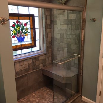 Fitzwater Construction - a glass shower with a bench - General Contractors Near Me