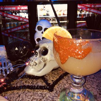 Sip N Puff - a drink in a glass with a slice of orange - Sports Bars Near Me - Modesto, California