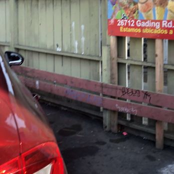 Sinaloa Searoll - a red car parked in front of a fence - Mexican Near Me - Hayward, California