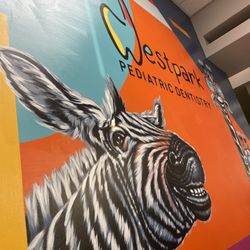 Westpark Pediatric Dentistry - Colorful mural with zebra and giraffe  Every room is inviting