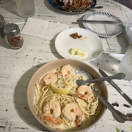 Shrimp scampi up close and eggplant Parmesan across the table. Shrimp scampi up close and eggplant Parmesan across the table.