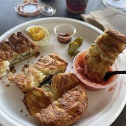 Spinach and cheese borekas with egg, pickles and grated tomatoes. Schug on the side. Spinach and cheese borekas with egg, pickles and grated tomatoes. Schug on the side.
