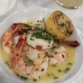 Bistro 135 - Shrimp Pomodoro - A seafood dish featuring shrimp in a light sauce, garnished with chopped chives and served with a stuffed lemon half, at Bistro 135 in Tracy, CA. - Italian Near Me - Tracy, California