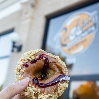 Revolution Doughnuts - a hand holding up a doughnut - Donuts Near Me - Decatur, Georgia Revolution Doughnuts - a hand holding up a doughnut - Donuts Near Me - Decatur, Georgia