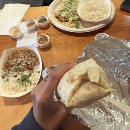 Chicken burrito and tacos with a side of rice and beans Chicken burrito and tacos with a side of rice and beans