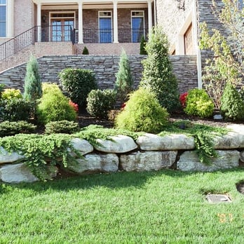 Ryno Lawn Care - a stone retaining wall in front of a house - Lawn Services Near Me - Lewisville, Texas Ryno Lawn Care - a stone retaining wall in front of a house - Lawn Services Near Me - Lewisville, Texas