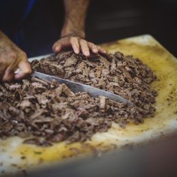 Photo of La Taqueria - San Francisco, CA, United States. Asada being cut!