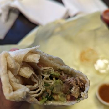 Lourdes - First bite into carne asada burrito - Mexican Near Me - Escondido, California Lourdes - First bite into carne asada burrito - Mexican Near Me - Escondido, California