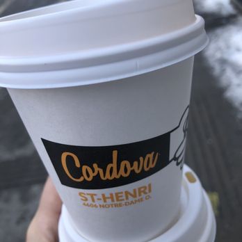 Cordova - a hand holding a cup of coffee - Coffee & Tea Near Me - Montreal, Quebec
