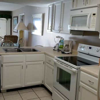ProActive Maintenance & Services - These cabinets were stained a medium brown and had a dated look. Refinished in Kitchen White. - Handyman Near Me - Youngstown, Florida ProActive Maintenance & Services - These cabinets were stained a medium brown and had a dated look. Refinished in Kitchen White. - Handyman Near Me - Youngstown, Florida