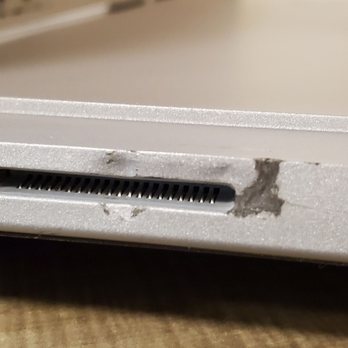 SquareTrade - There's a strange burn / black residue on the charging port, and you can see the strange dent and/or chip in the center of the port. - Mobile Phone Repair Near Me - Brisbane, California SquareTrade - There's a strange burn / black residue on the charging port, and you can see the strange dent and/or chip in the center of the port. - Mobile Phone Repair Near Me - Brisbane, California
