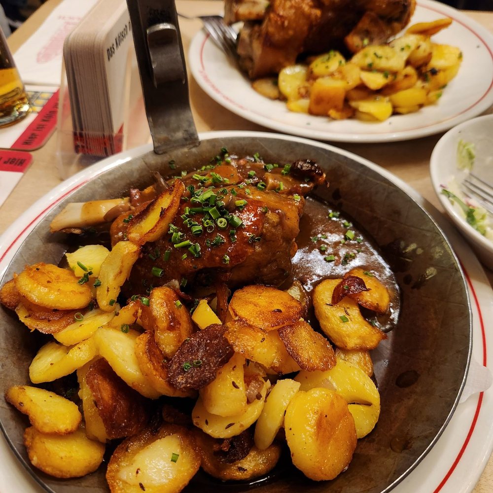 Peters Brauhaus - Brauhaus Pfanne and Pork Knuckle in the background. Bacon fried potatoes - German Near Me - Cologne, NW Peters Brauhaus - Brauhaus Pfanne and Pork Knuckle in the background. Bacon fried potatoes - German Near Me - Cologne, NW